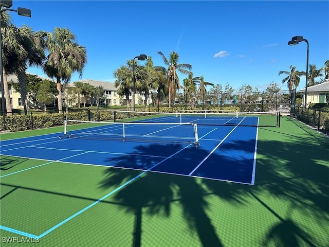 view of tennis court with fence