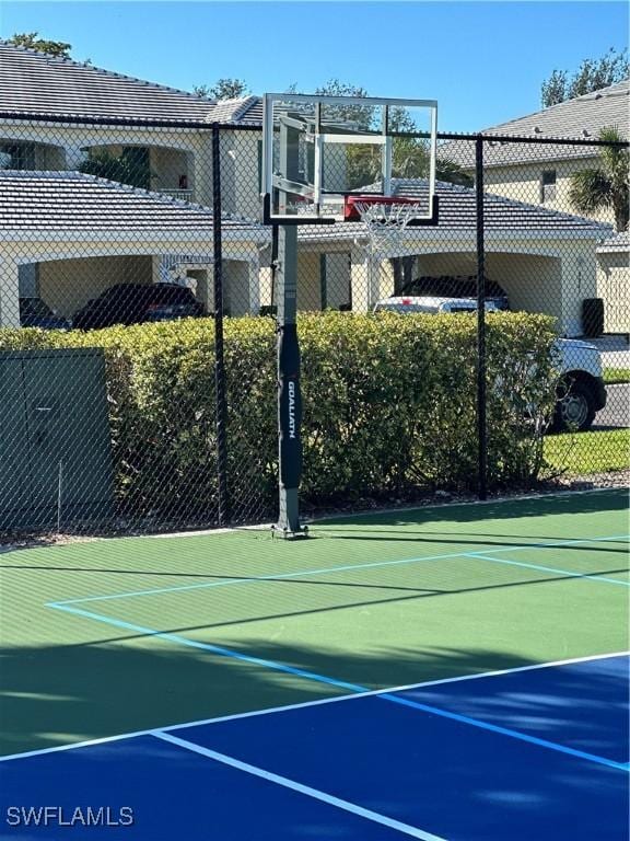 view of basketball court with community basketball court and fence