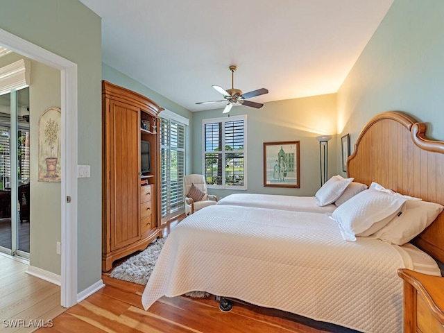 bedroom featuring ceiling fan, light hardwood / wood-style flooring, and access to exterior