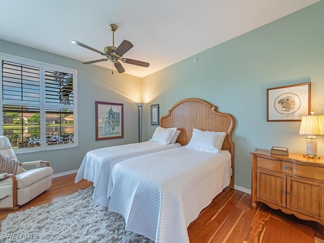 bedroom featuring ceiling fan and dark hardwood / wood-style floors