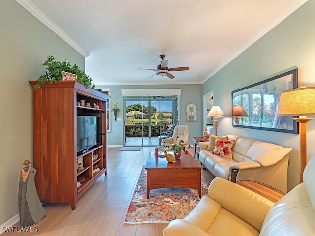 living room featuring light hardwood / wood-style floors, ceiling fan, and crown molding