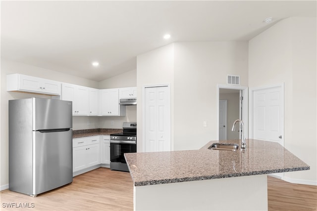 kitchen featuring dark stone countertops, stainless steel appliances, sink, and white cabinets