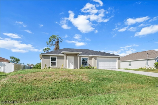 view of front of property with a front yard and a garage