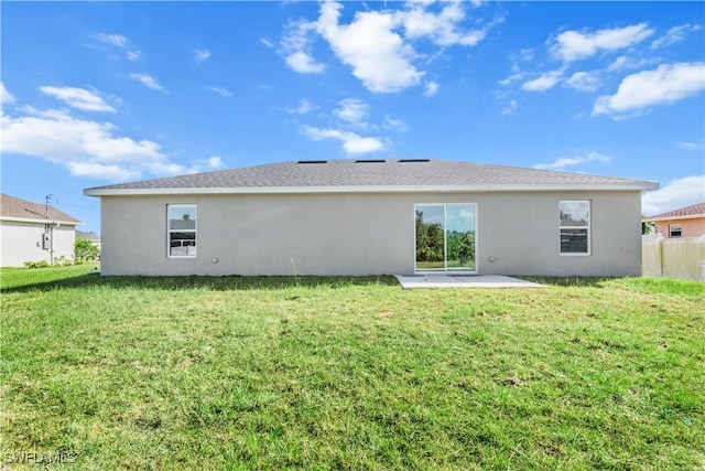 rear view of property with a yard and a patio