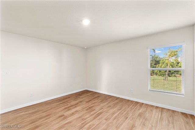 unfurnished room with light wood-type flooring