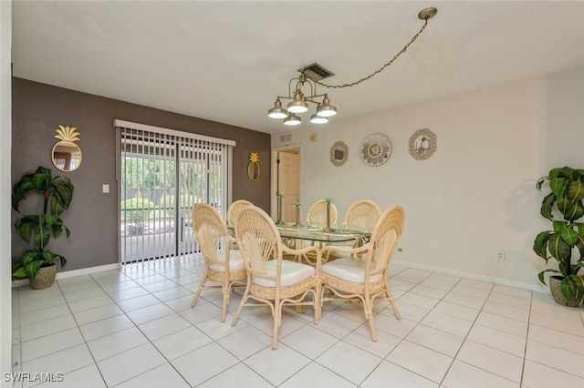 dining area featuring light tile patterned floors and a notable chandelier