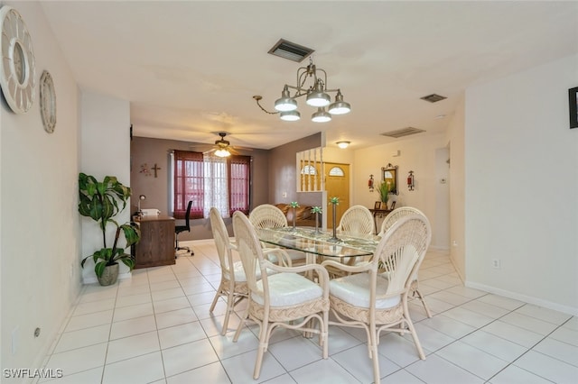 dining area featuring ceiling fan with notable chandelier and light tile patterned flooring