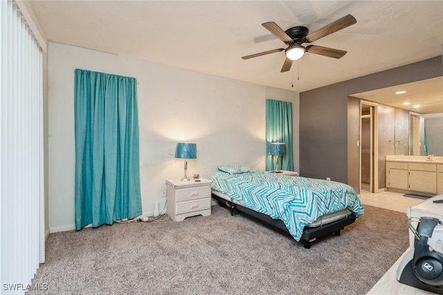 carpeted bedroom featuring ceiling fan, ensuite bath, and sink