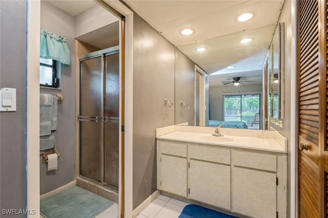 bathroom featuring tile patterned flooring, ceiling fan, walk in shower, and vanity