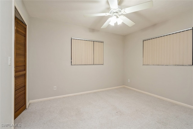 carpeted empty room with ceiling fan