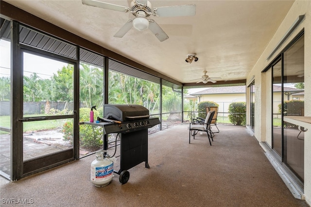 sunroom / solarium featuring ceiling fan