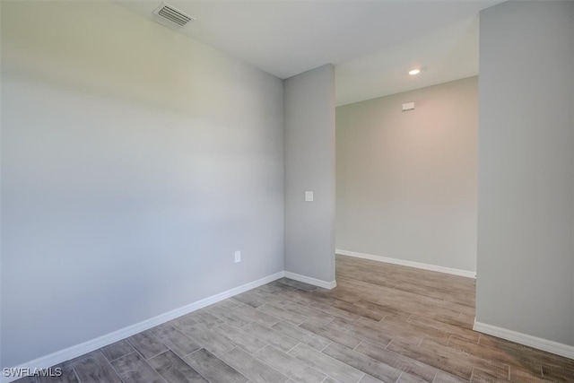 unfurnished room featuring light hardwood / wood-style floors