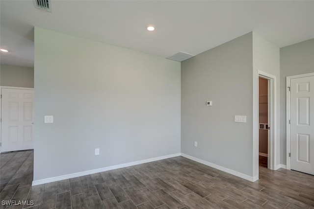 unfurnished room with dark hardwood / wood-style floors