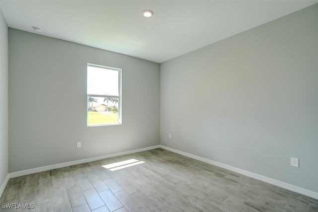 unfurnished room with light wood-type flooring