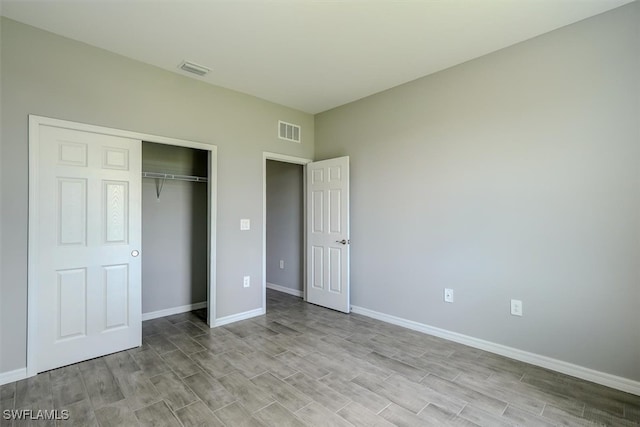 unfurnished bedroom featuring a closet and light hardwood / wood-style floors