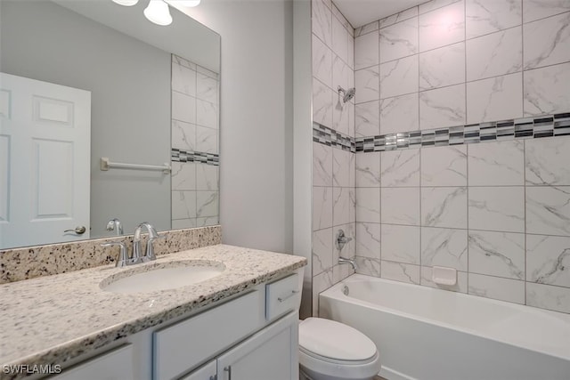 full bathroom with tiled shower / bath combo, vanity, and toilet