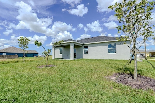 back of house featuring a yard