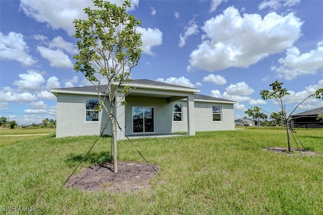 rear view of house with a yard