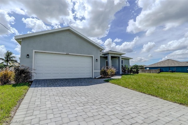 single story home with a garage and a front lawn