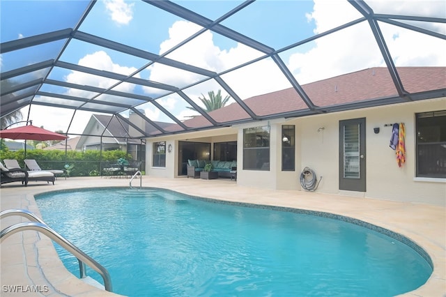 view of swimming pool featuring glass enclosure and a patio area