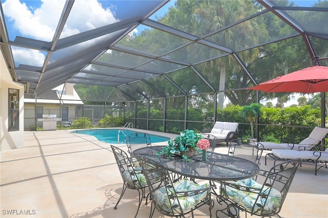 view of pool with glass enclosure and a patio area