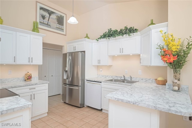 kitchen with stainless steel fridge, white cabinets, pendant lighting, white dishwasher, and sink