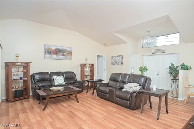 living room with light hardwood / wood-style flooring and vaulted ceiling