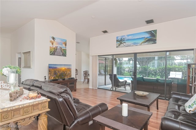 living room featuring vaulted ceiling and hardwood / wood-style flooring