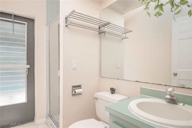 bathroom with tile patterned flooring, vanity, toilet, and an enclosed shower