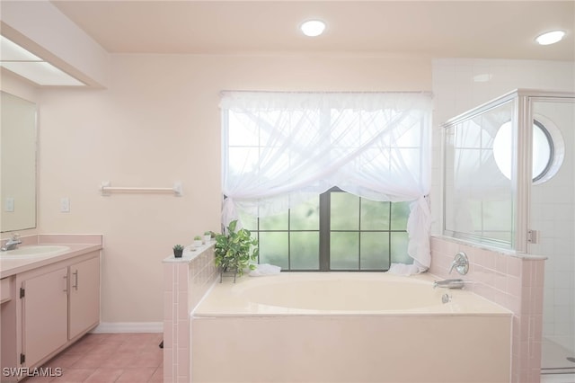 bathroom with plus walk in shower, tile patterned floors, and vanity