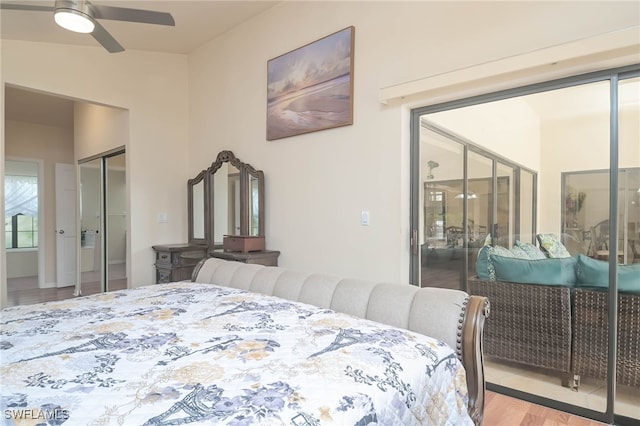 bedroom featuring light wood-type flooring, lofted ceiling, and ceiling fan