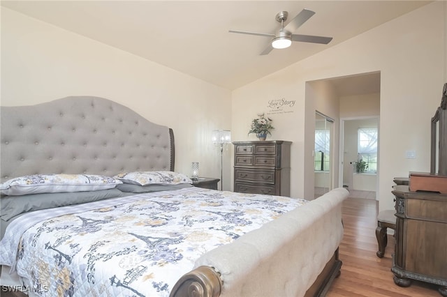 bedroom with ceiling fan, light wood-type flooring, and vaulted ceiling