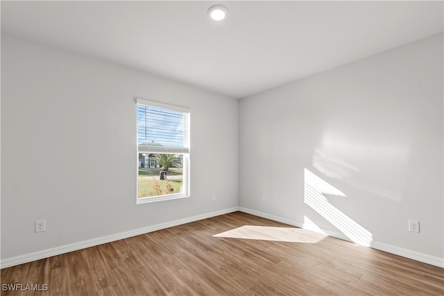 spare room with hardwood / wood-style flooring