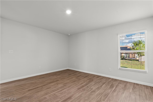 empty room with hardwood / wood-style floors