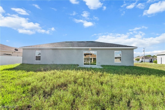 rear view of house with a lawn