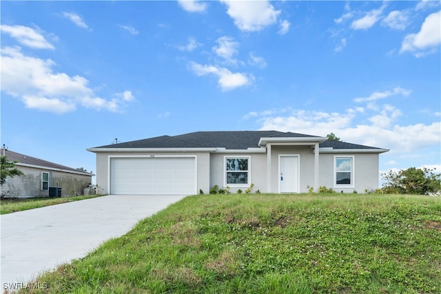 ranch-style home with central AC unit and a garage