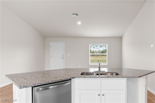 kitchen with sink, white cabinetry, light hardwood / wood-style floors, stainless steel dishwasher, and light stone counters