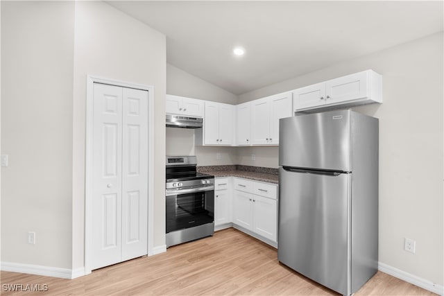 kitchen with vaulted ceiling, appliances with stainless steel finishes, light wood-type flooring, and white cabinetry