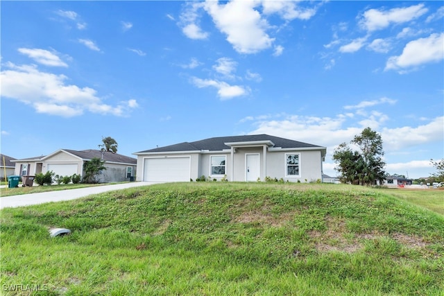 single story home featuring a garage and a front lawn