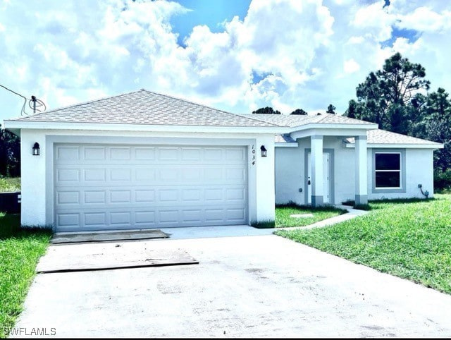 1034 Pilgrim St E, Lehigh Acres, FL 33974 - single story home with concrete driveway, stucco siding, an attached garage, and a front lawn