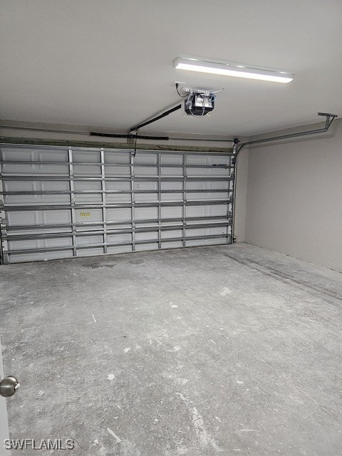 1034 Pilgrim St E, Lehigh Acres, FL 33974 - garage featuring a garage door opener