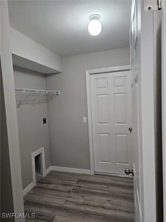 laundry area with hookup for an electric dryer, a fireplace, and dark wood-type flooring