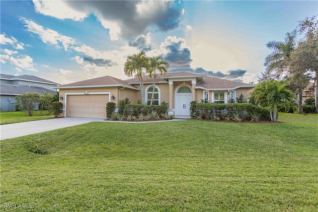 view of front of property with a front yard and a garage