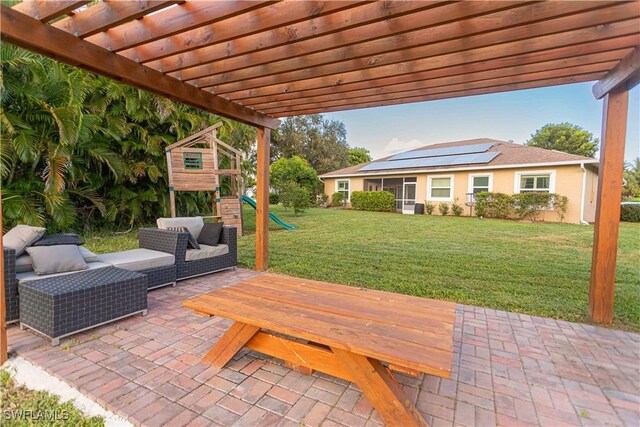 view of patio featuring outdoor lounge area, a pergola, and a playground