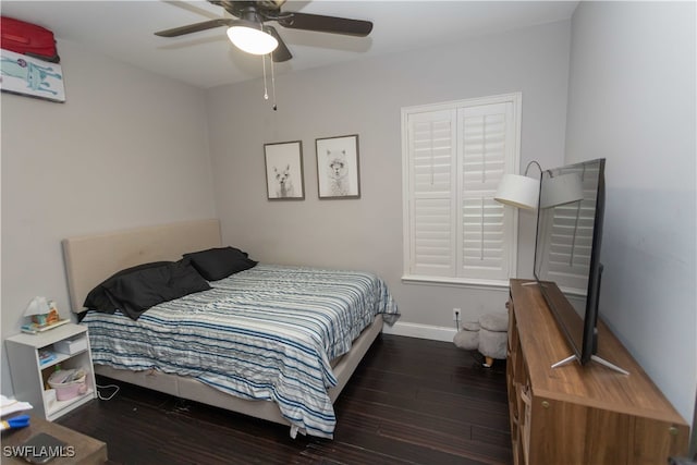 bedroom with ceiling fan and dark wood-type flooring