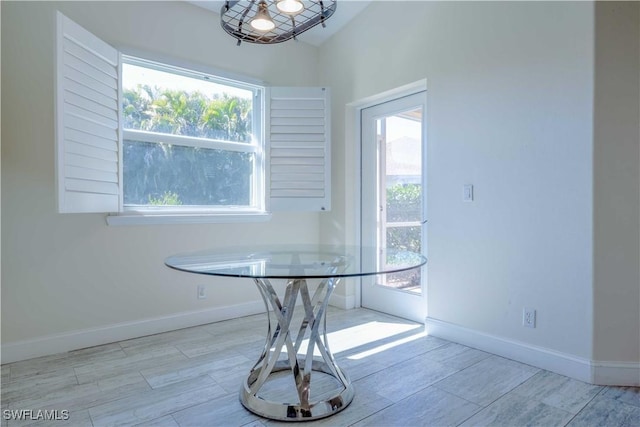 20730 Groveline Ct, Estero, FL 33928 - dining room featuring baseboards and wood finished floors