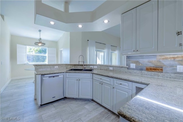 20730 Groveline Ct, Estero, FL 33928 - kitchen featuring dishwasher, white cabinets, light stone countertops, recessed lighting, and a peninsula