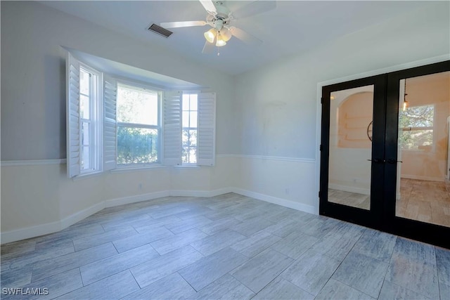 20730 Groveline Ct, Estero, FL 33928 - empty room featuring french doors, a ceiling fan, and wood tiled floors