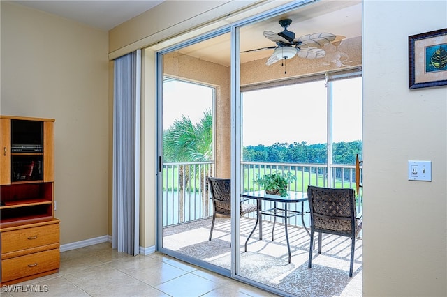 doorway to outside featuring light tile patterned floors and ceiling fan