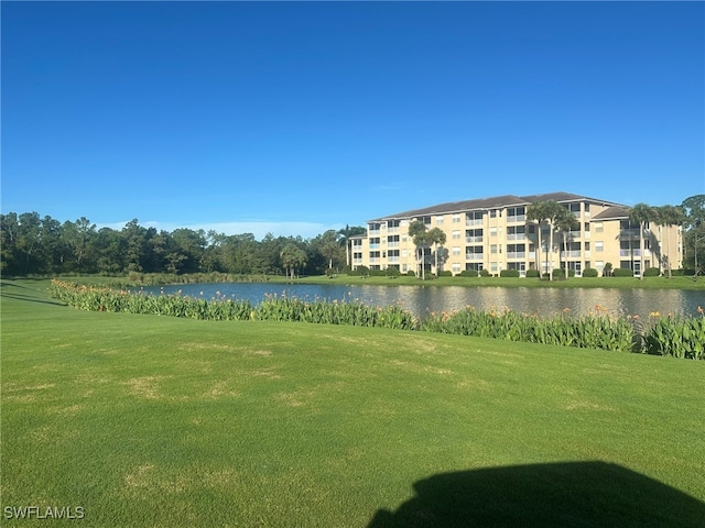 surrounding community featuring a yard and a water view